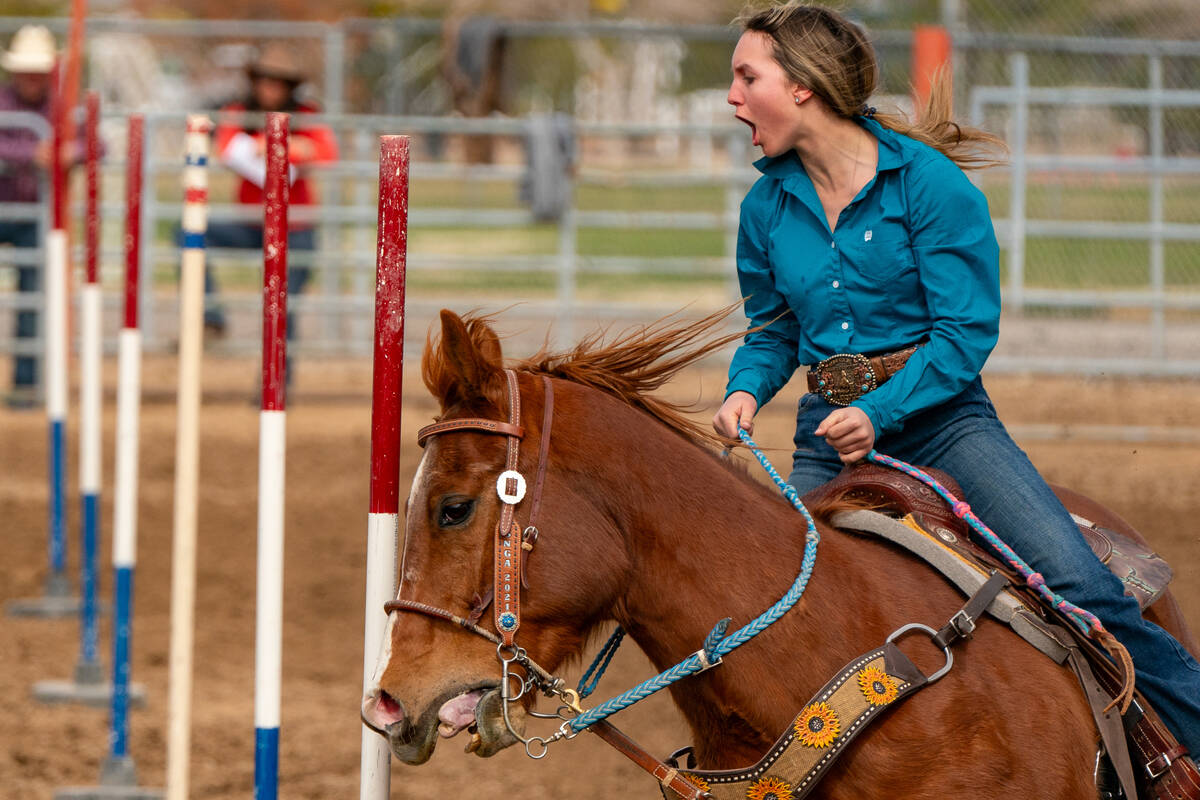 A woman yells as she is on horseback as she is going around the obstacle course at the Pahrump ...