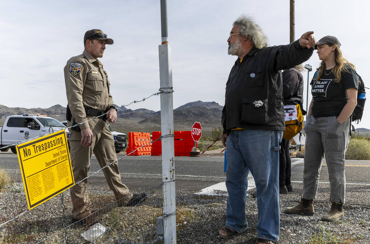 Brian Terrell with the Nevada Desert Experience confers with Nye County Sheriff's Officer John ...