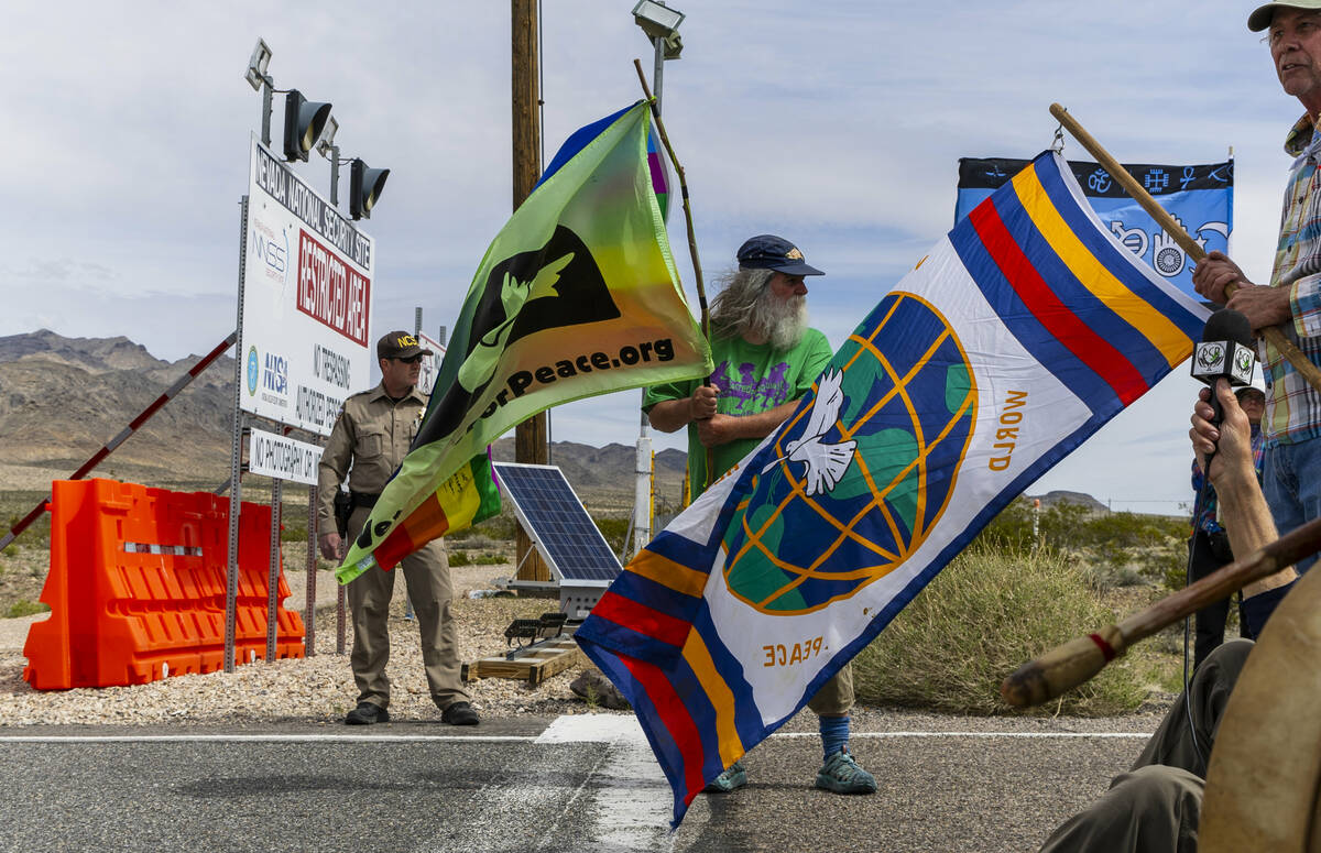 Chris Pinney from Walla Walla, Wash., holds a peace flag beside the security line at the entry ...