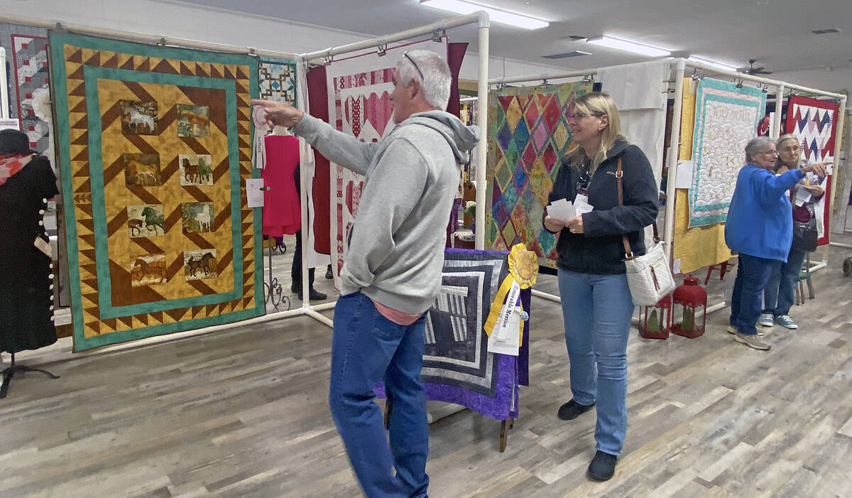 Robin Hebrock/Pahrump Valley Times Pins and Needles Quilt Show attendees are pictured perusing ...