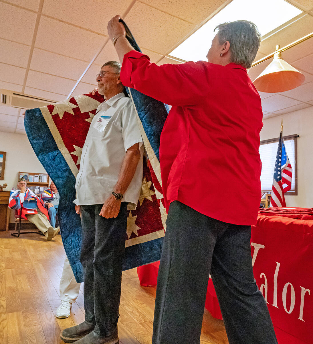 John Clausen/Pahrump Valley Times An Amargosa veteran stands tall as his Quilt of Valor is drap ...