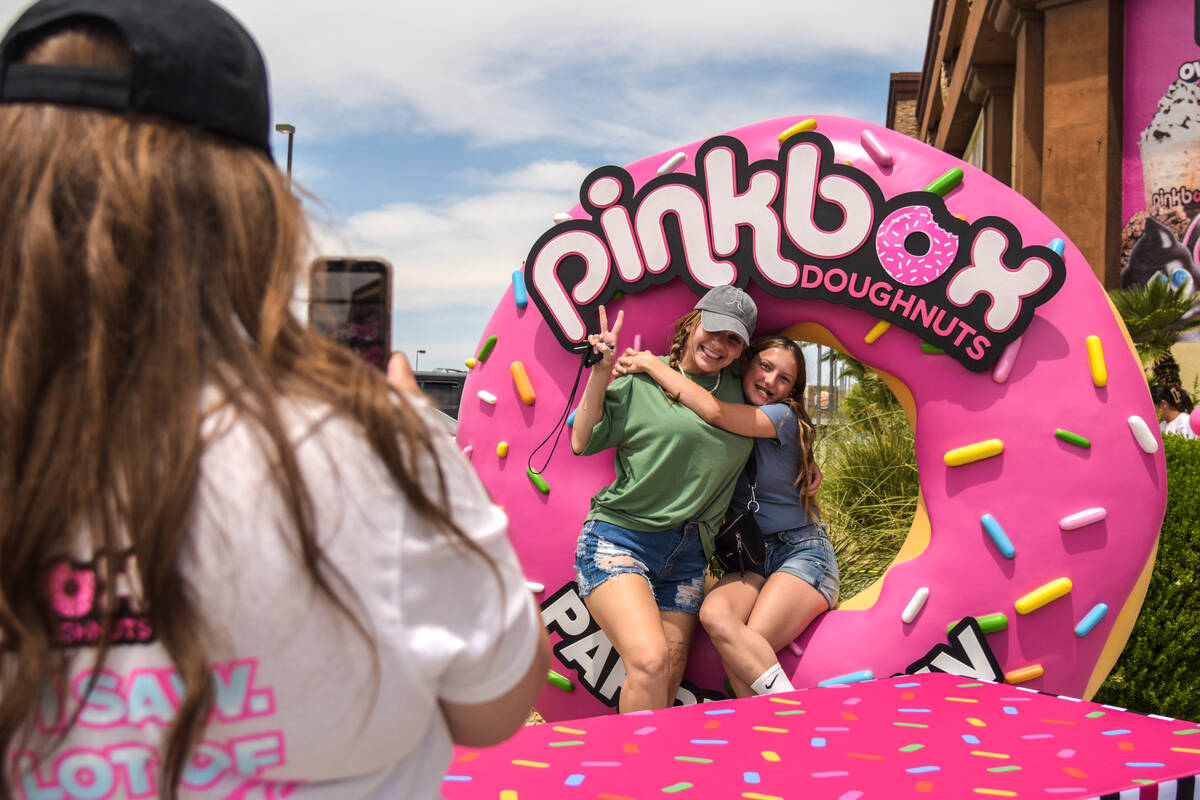 Emily Elgin (middle) and Rowan Elgin (middle) are taking a picture with a permanent Pinkbox Dou ...