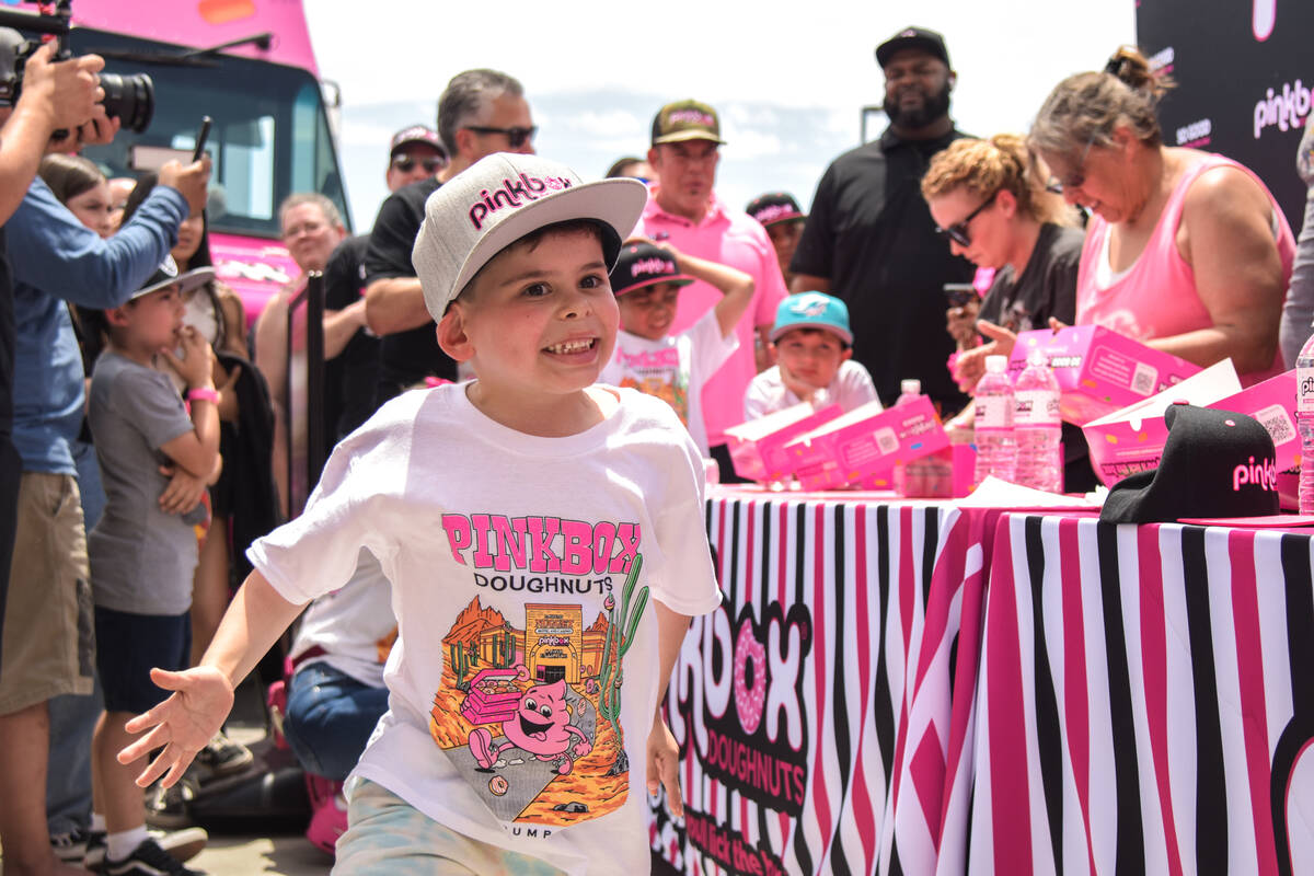 One of Stephen Seigel and Judith Perez Seigel's kids hypes up the crowd before the adult eating ...