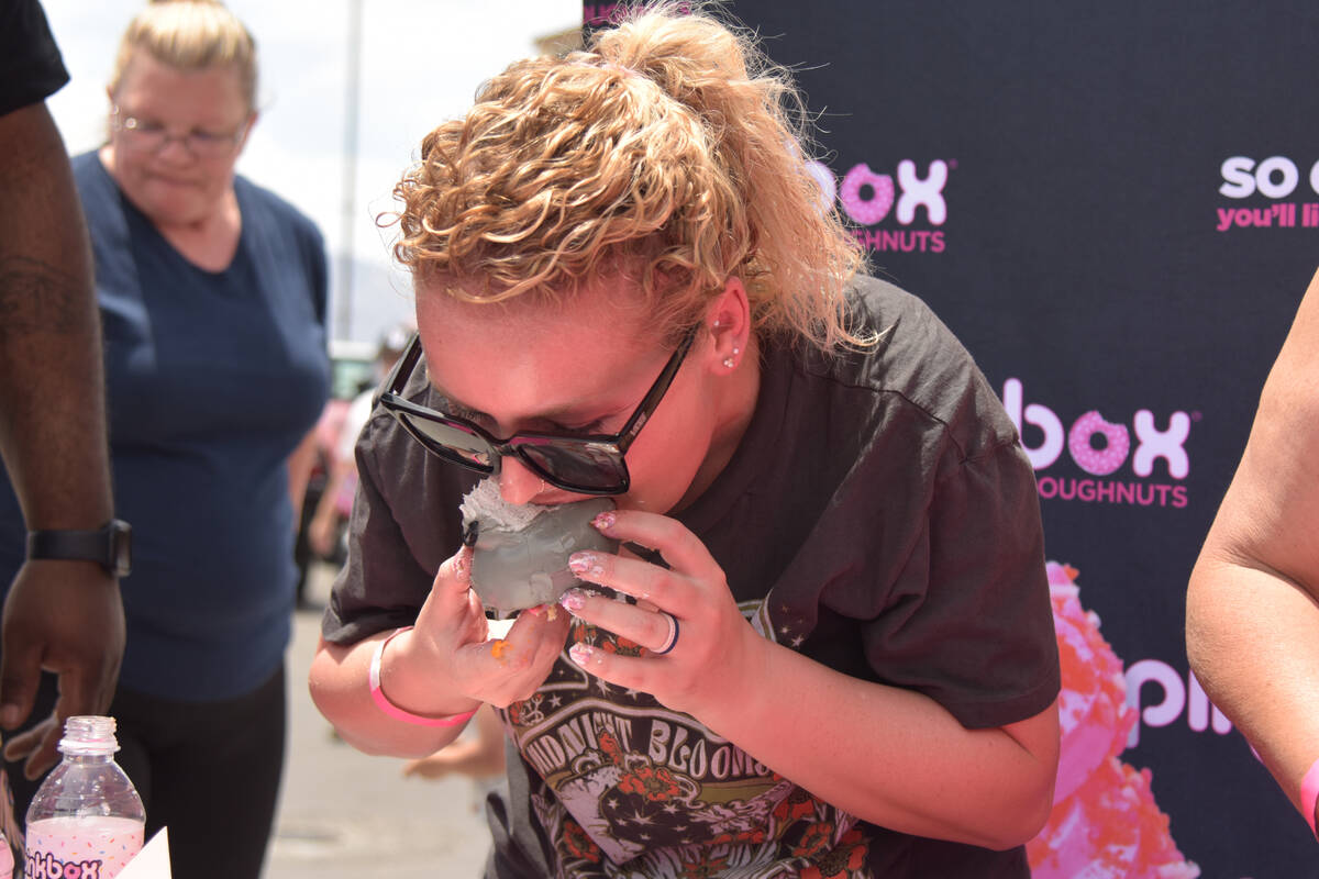 Rachel Garcia eating a doughnut in the adult eating contest for the grand opening of the Pinkbo ...