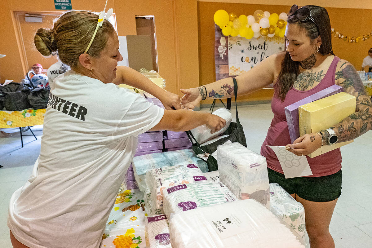 John Clausen/Pahrump Valley Times A Community Baby Shower volunteer is shown assisting an atten ...