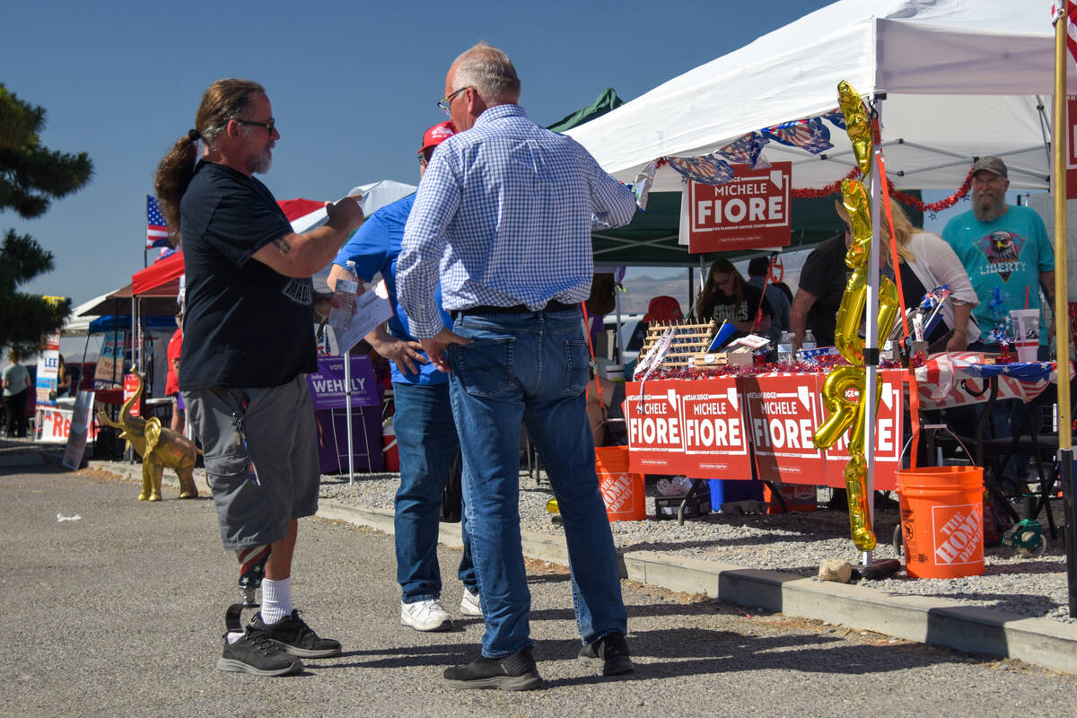 Randell Saltzman (left) speaks with Bill Hockstedler (right ) a Pahrump resident and voter in t ...