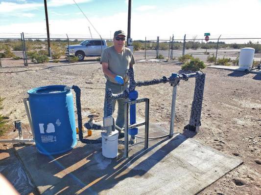 Special to the Pahrump Valley Times John Klenke takes water samples at the Amargosa Senior Cent ...