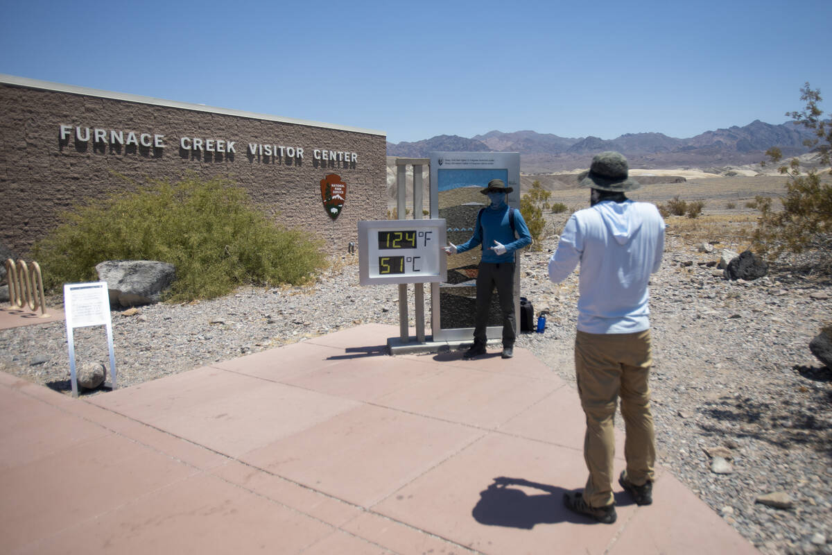 Marsh Doshi, right, takes a photograph of Malhar Bhoite, left, at the Furnace Creek Visitor Cen ...