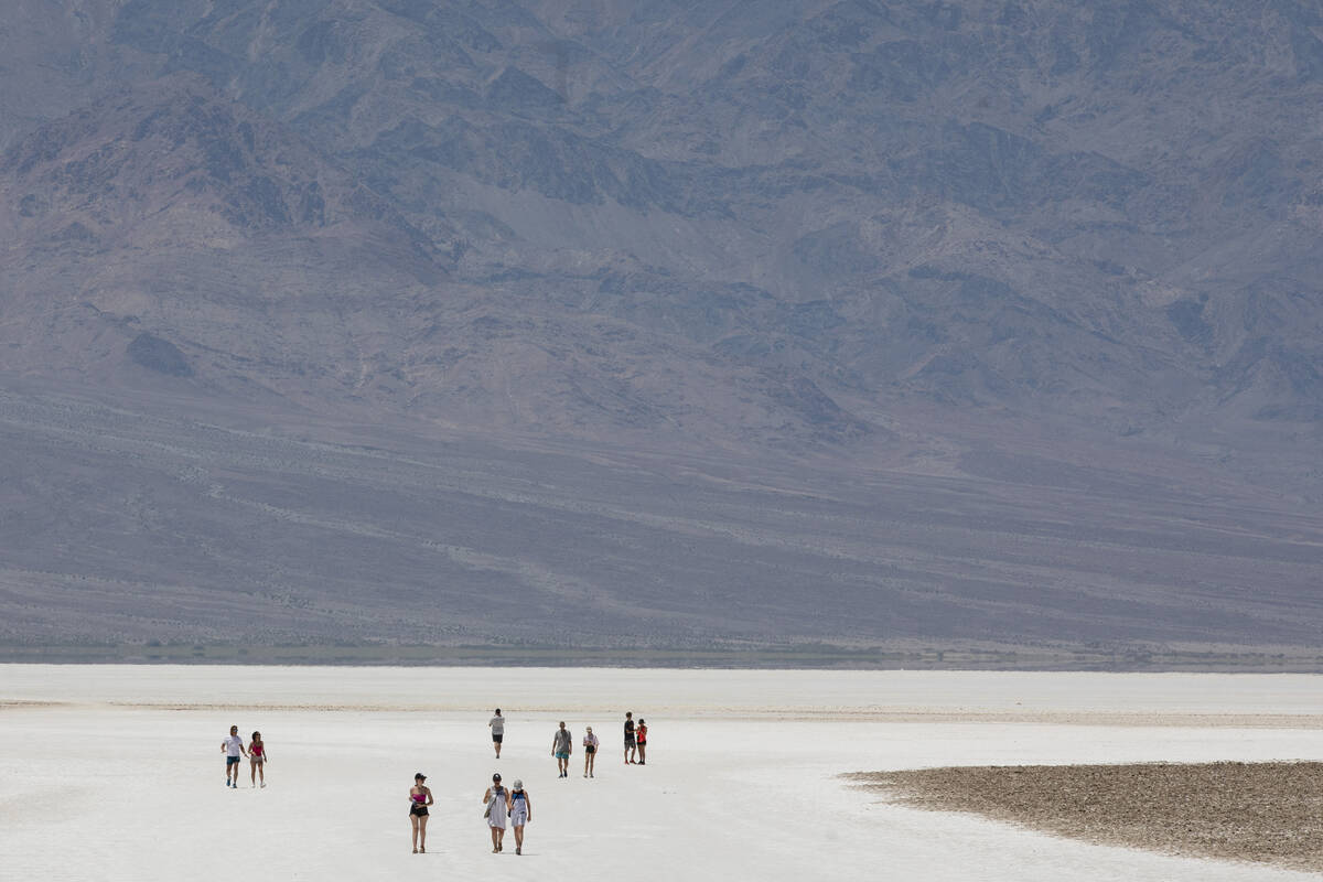 Tourists visit Badwater Basin on Monday, July 8, 2024, in Death Valley National Park, Calif. (D ...