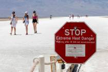 A stop sign warns tourists of extreme heat at Badwater Basin on Monday, July 8, 2024, in Death ...