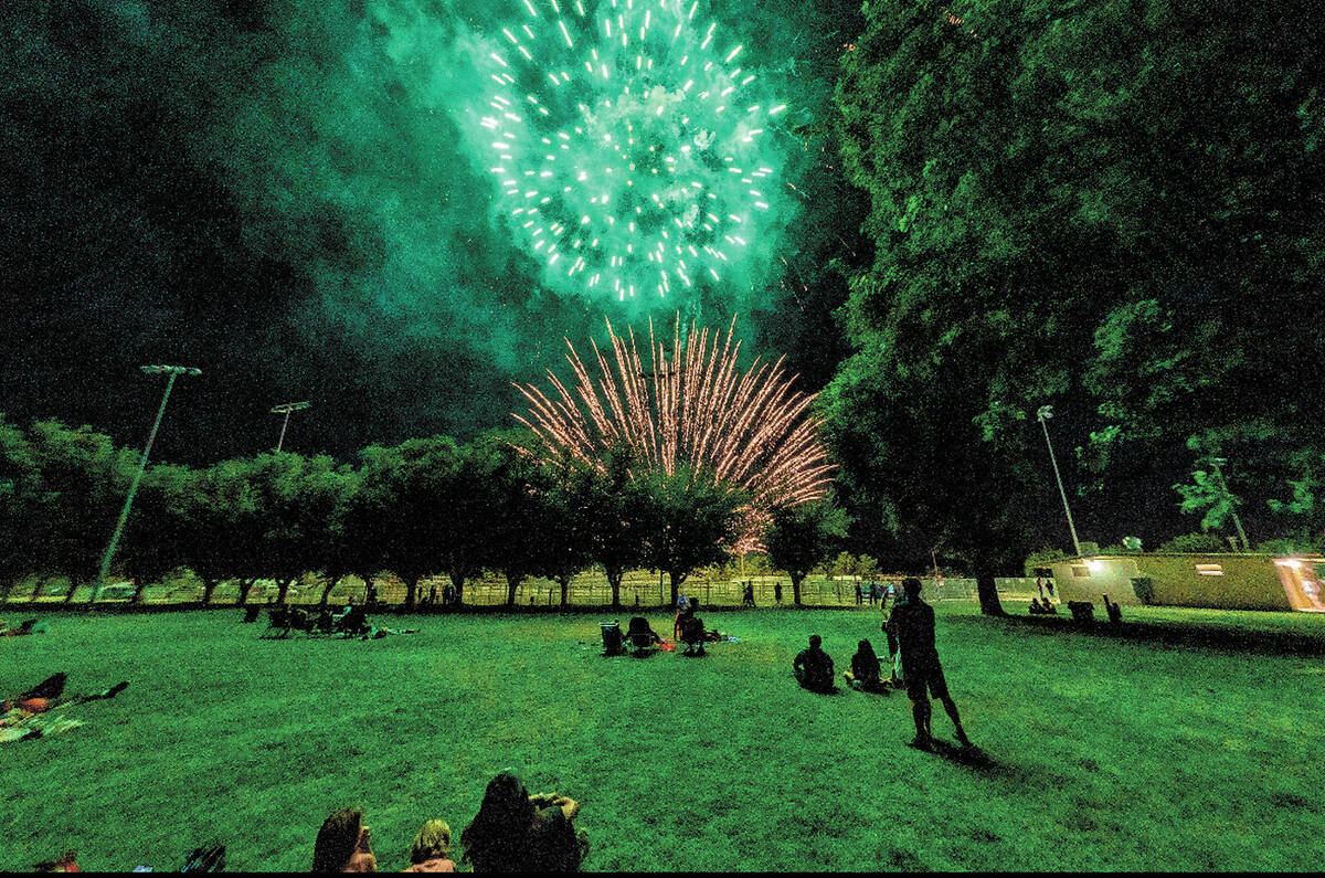 John Clausen/Pahrump Valley Times People relaxed on the lawn at Petrack Park and gazed upward f ...