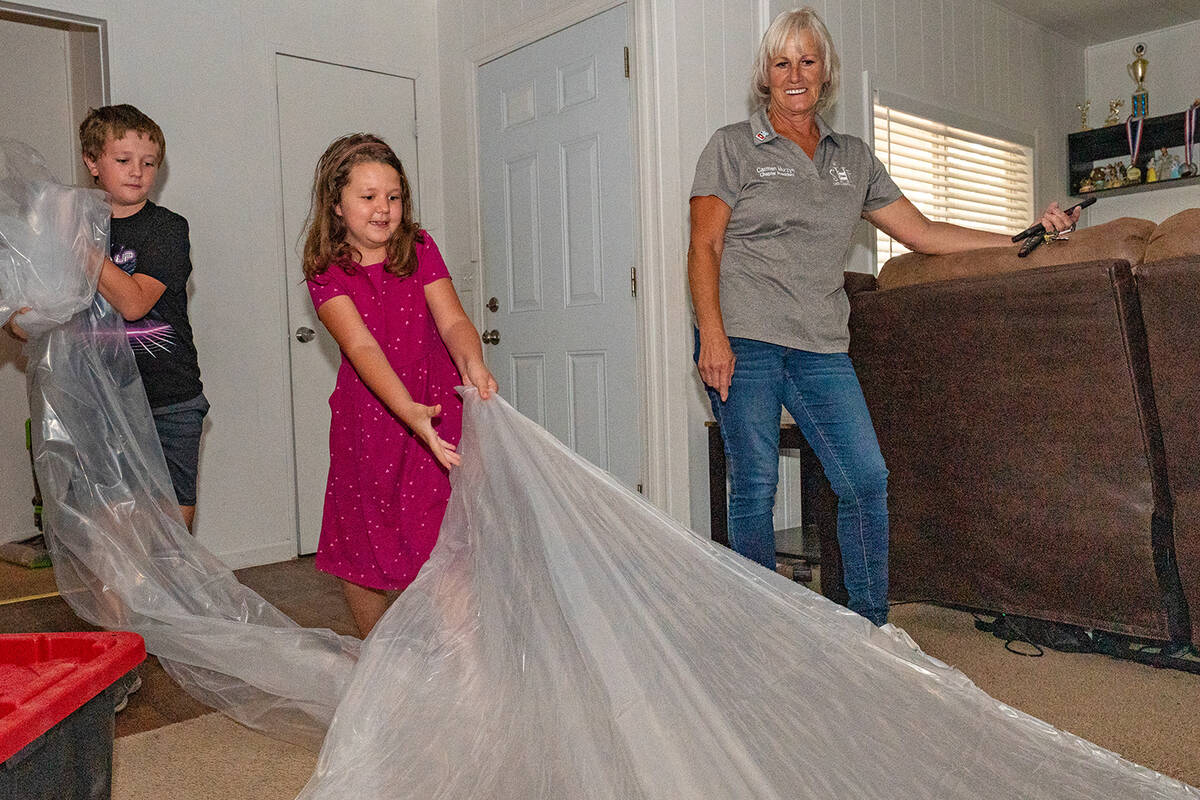 John Clausen/Pahrump Valley Times Two very excited youngsters pull the plastic off of their bra ...