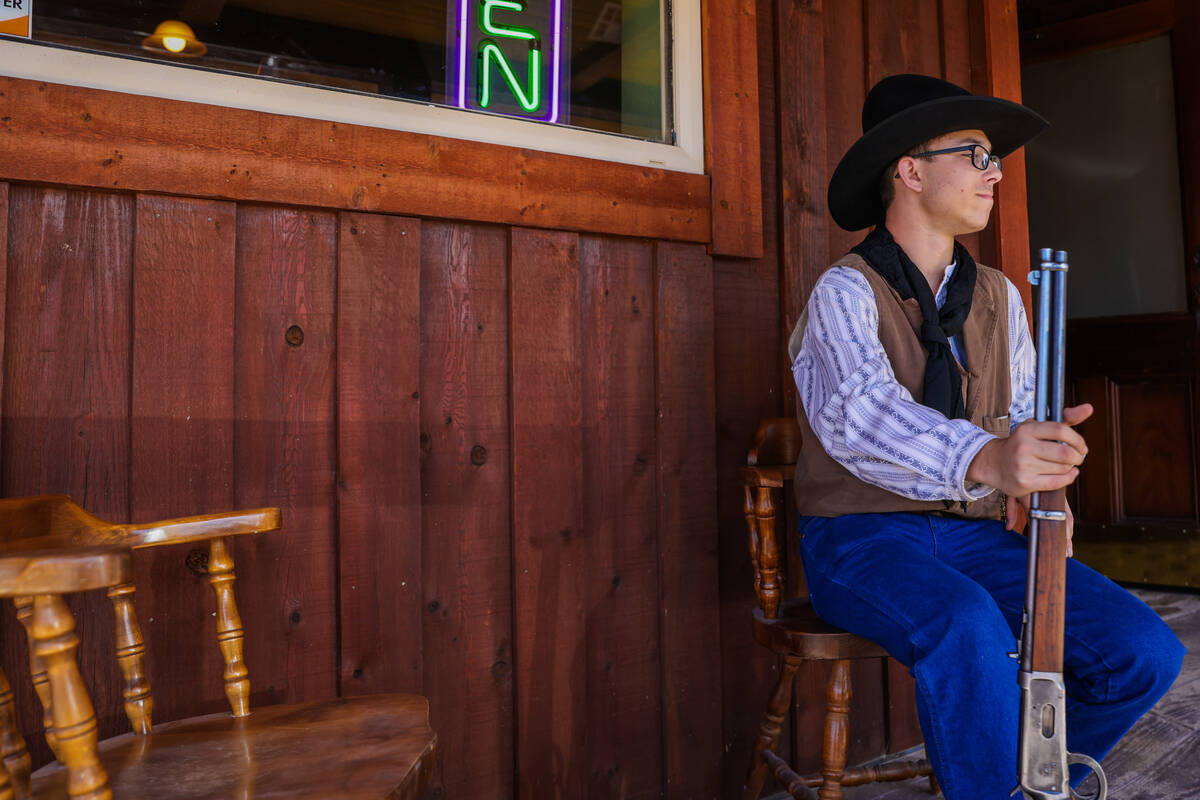 Aden Hale of Dayton, Nev., sits on a porch during Goldfield Days on Saturday, Aug. 3, 2024, in ...