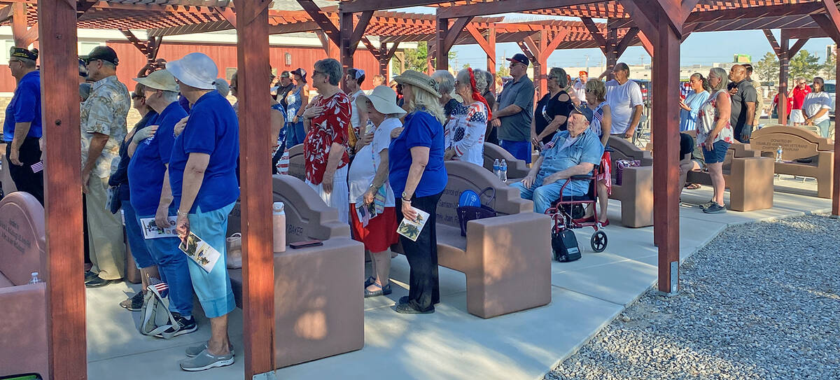 Robin Hebrock/Pahrump Valley Times Purple Heart Day Ceremony attendees are shown with their han ...