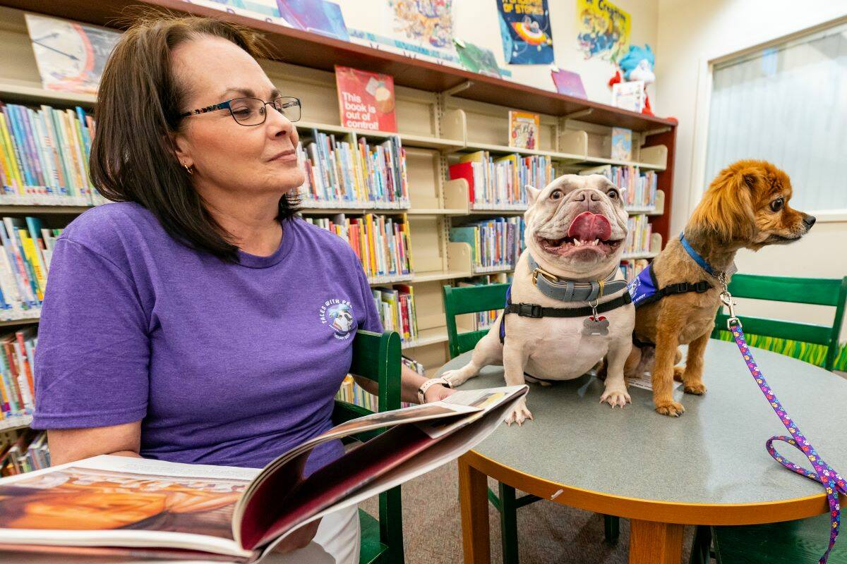 John Clausen/Pahrump Valley Times Program creator Dee Mounts reads to her therapy dog Diesel Du ...