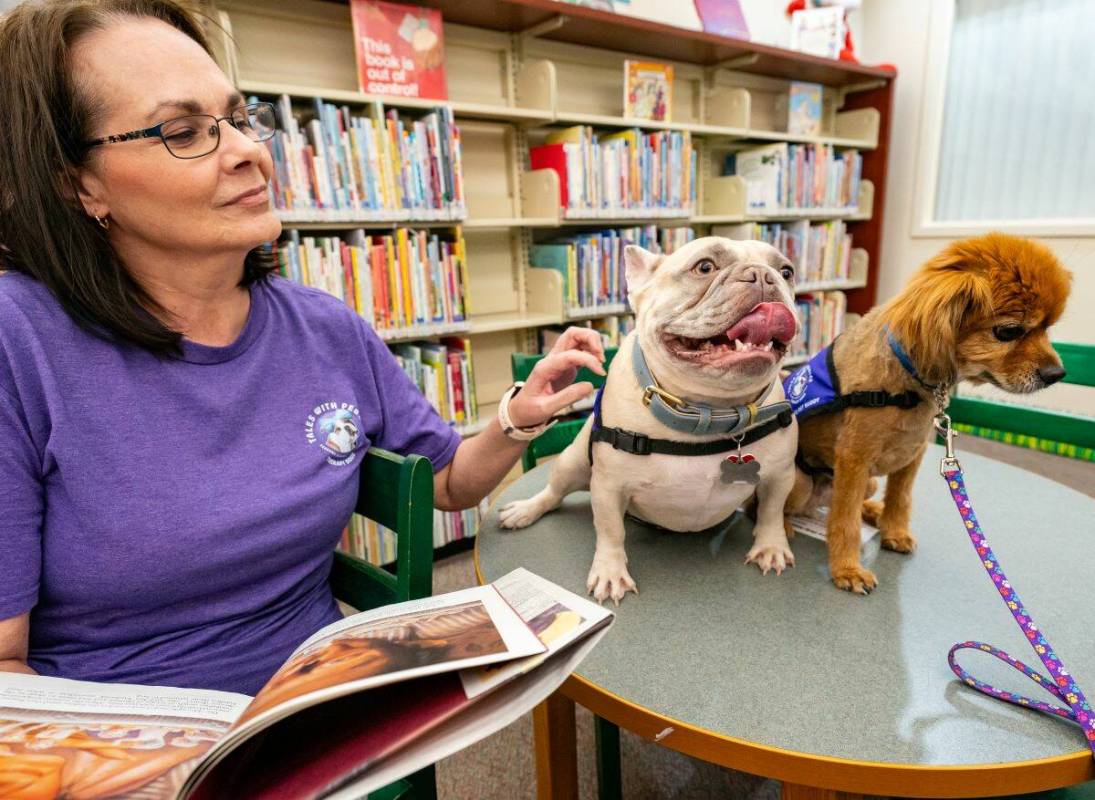 John Clausen/Pahrump Valley Times Program creator Dee Mounts reads to her therapy dog Diesel Du ...