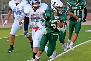 Beatty's Yudiel Gutierrez returns a punt while the Owyhee players attempt to catch up in a non- ...