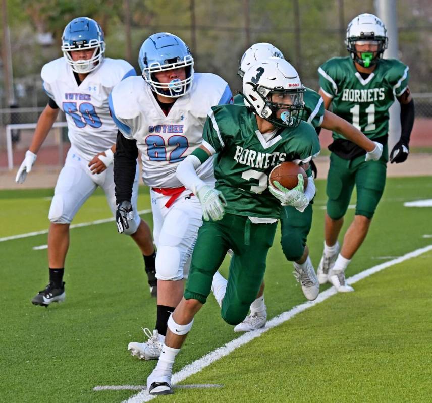 Beatty's Yudiel Gutierrez returns a punt while the Owyhee players attempt to catch up in a non- ...