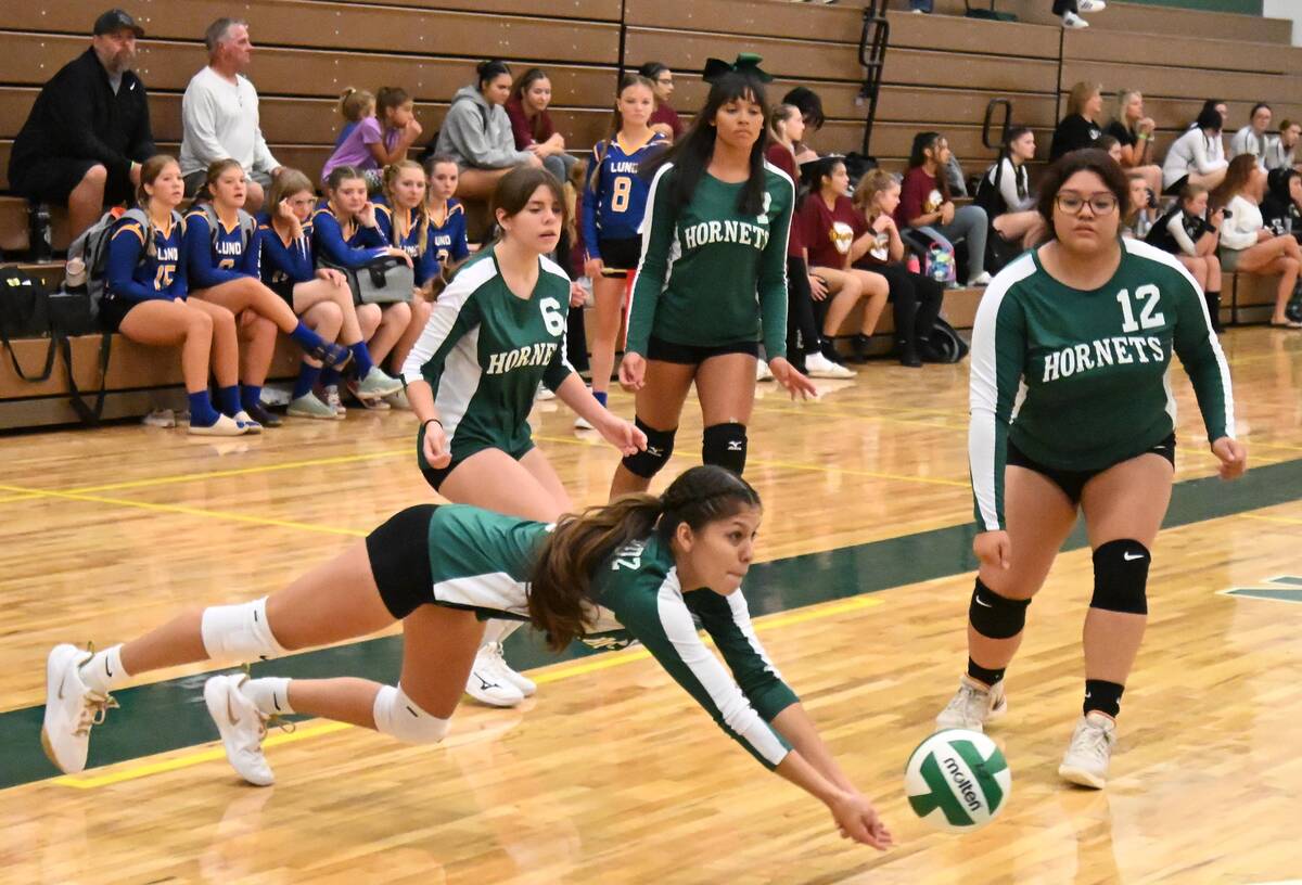 Beatty's Elizama De La Cruz digs at the ball from the Liberty Baptist Academy players on Friday ...