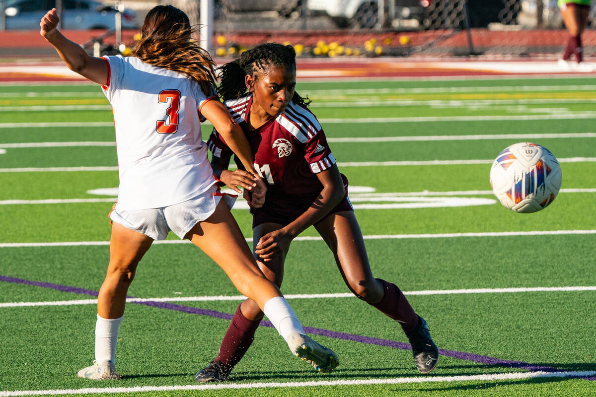 Trojan’s (right) Diona Nixon (11) attempts to get past a Chaparral Cowboy player to take ...