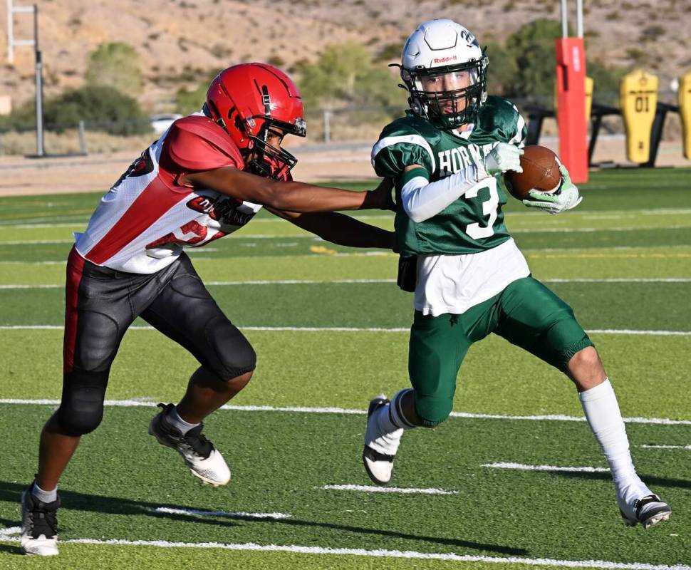 Beatty Hornet Yudiel Rodriguez (3) carries the ball while avoiding a Beaver Dam Diamondback pla ...