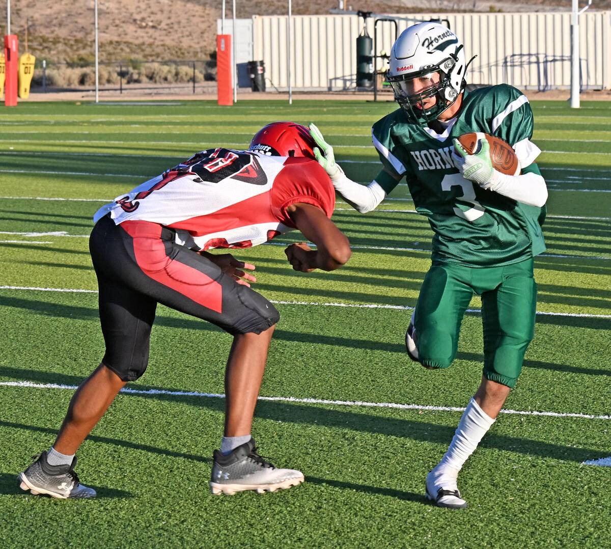 Beatty Hornet Yudiel Rodriguez (3) carries the ball and pushes a Beaver Dam Diamondback player ...