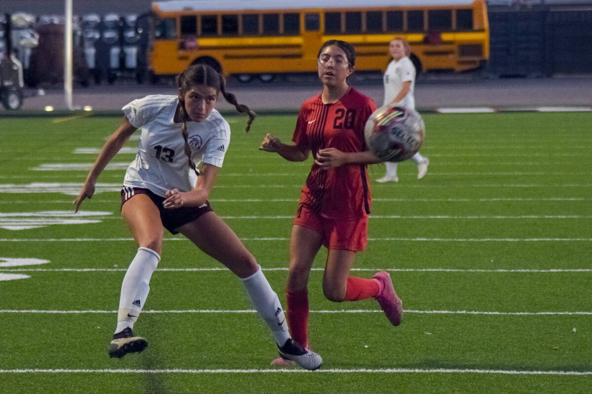 Pahrump Valley’s Ryleigh Denton (13) (left) kicks the ball at the Mater Academy East Las ...