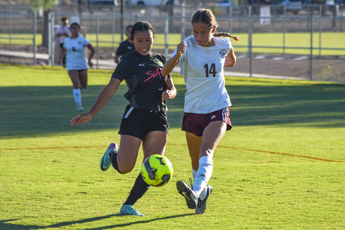 Pahrump Valley’s Rosie Miller (14) (right) runs with the ball towards the penalty box ag ...