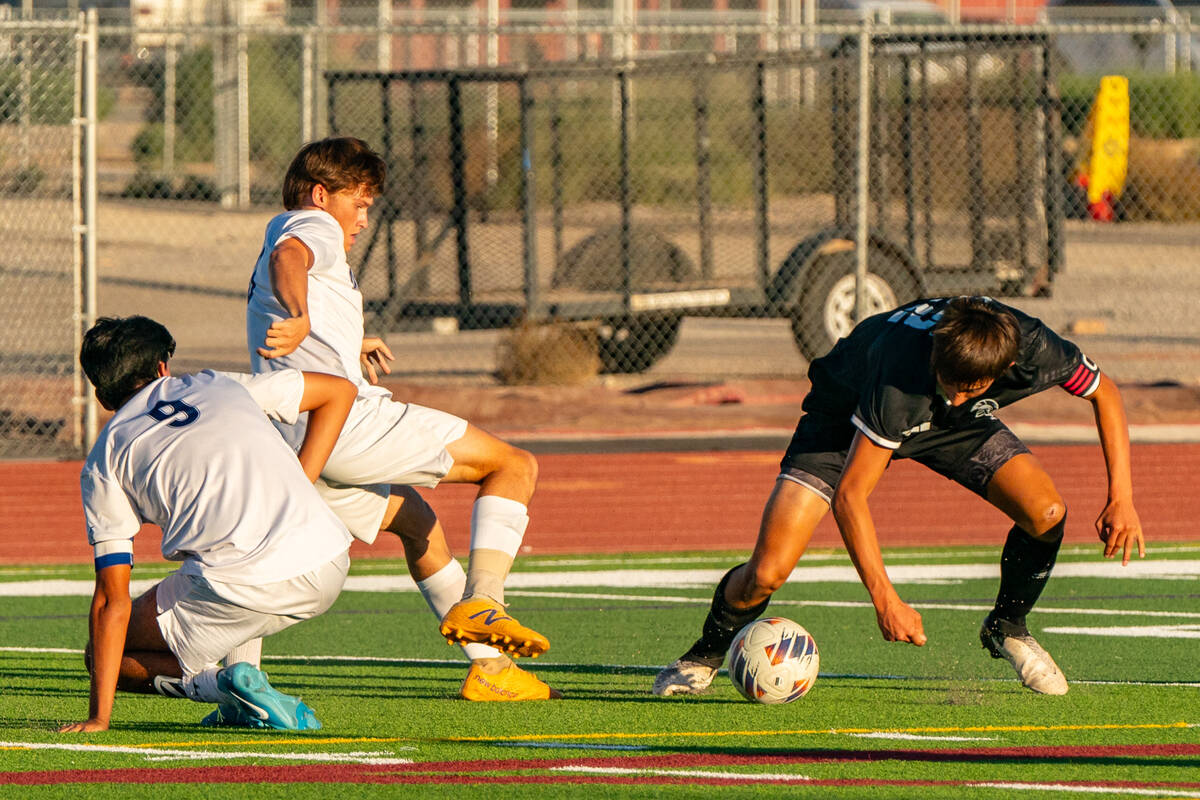 Trojan's Cayden Cowley (22) fights for the ball against The Meadows School on Tuesday, Sept 24, ...