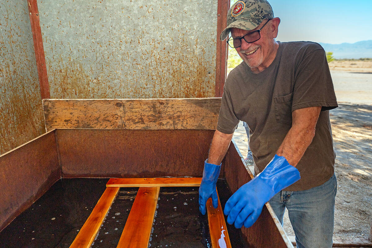 John Clausen/Pahrump Valley Times Working the staining station, a volunteer for Sleep in Heaven ...