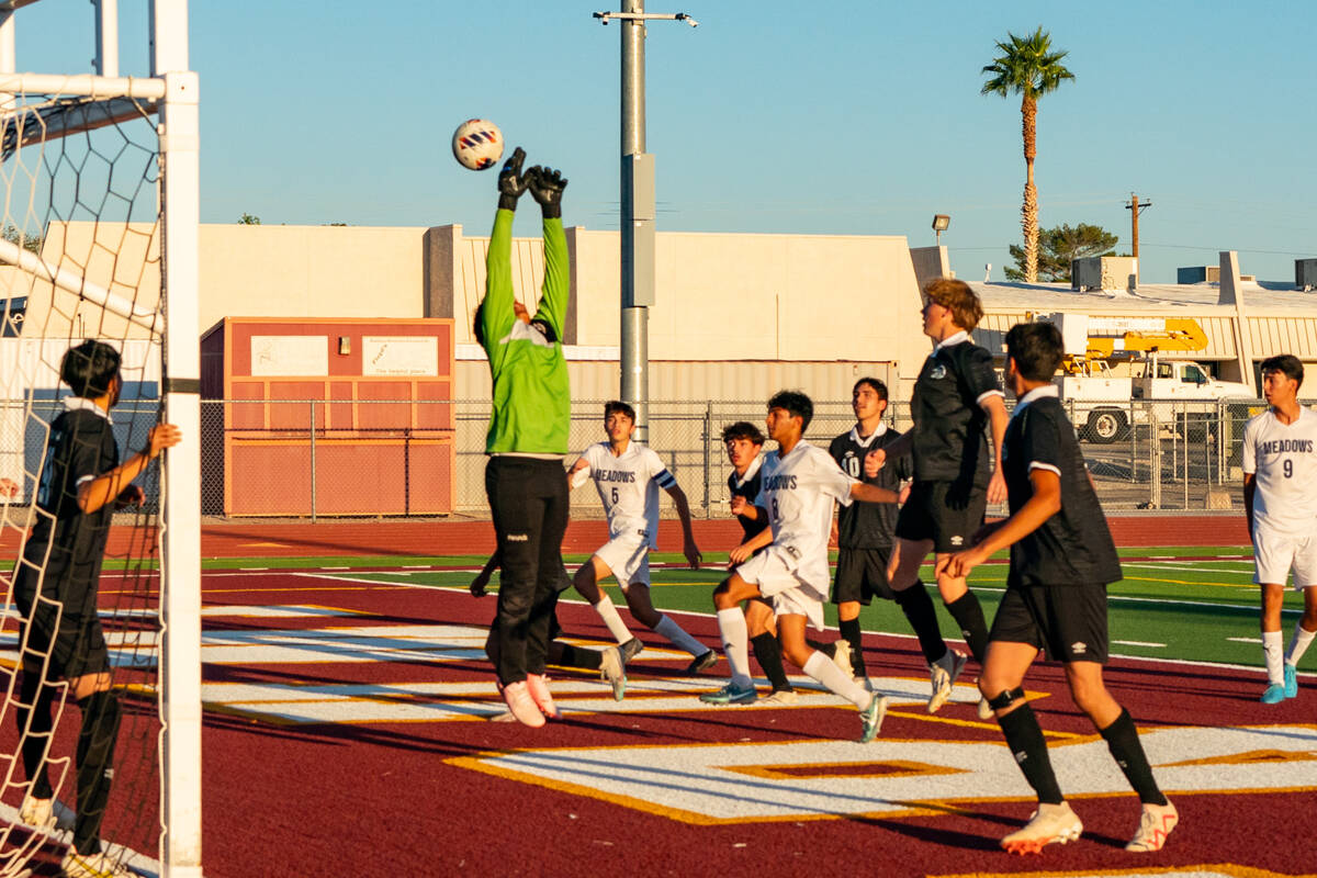 Trojans goaltender attempts to block a ball coming from The Meadows School on Tuesday, Sept. 24 ...