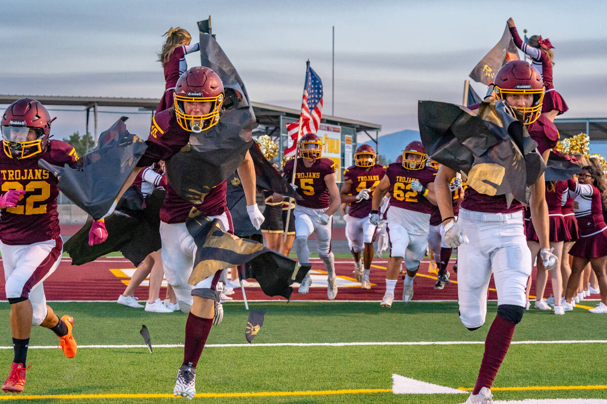 The Pahrump Valley football team runs onto the field to play their first game of the 2024-25 fo ...