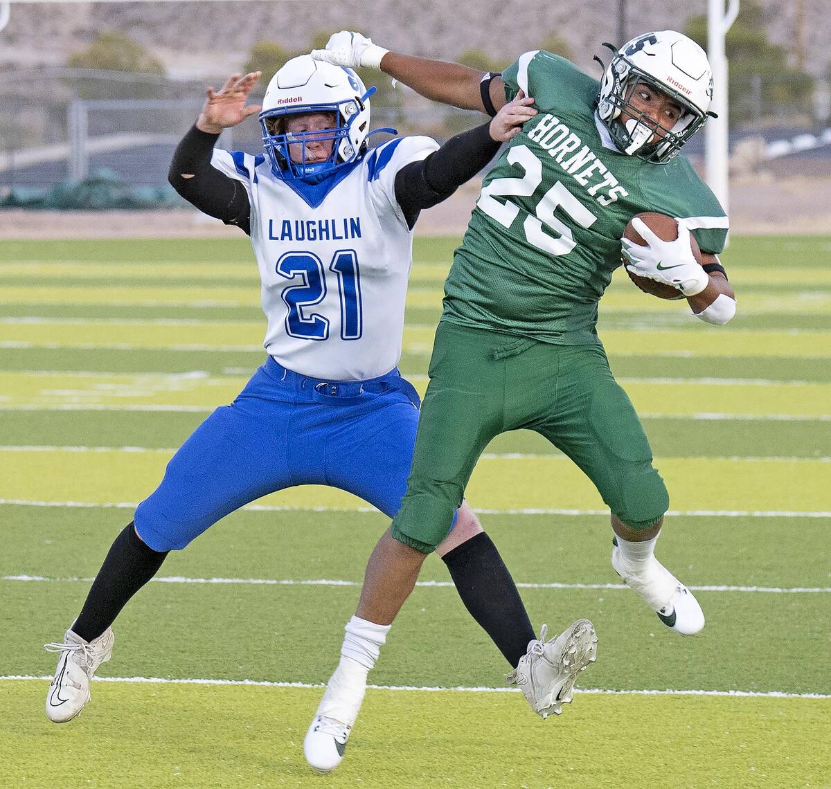 Beatty's Anthoni Aguila (25) holds off a Laughlin Cougars in a landslide game in favor of the H ...