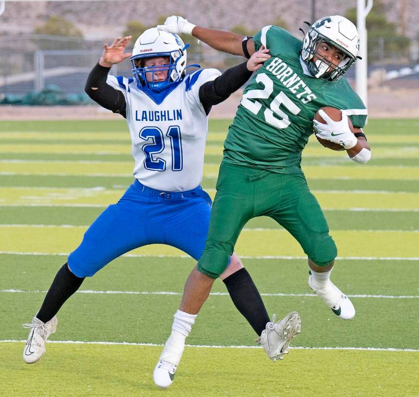 Beatty's Anthoni Aguila (25) holds off a Laughlin Cougars in a landslide game in favor of the H ...