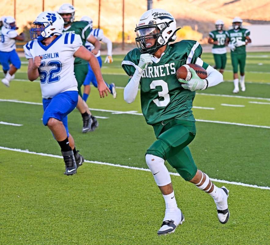 Hornets Yudiel Gutierrez (3) runs the ball away from the Laughlin Cougars after catching the ba ...