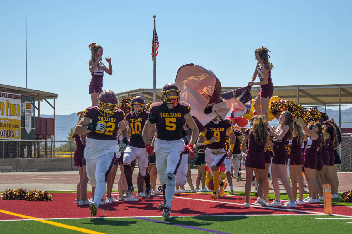 Trojans football team runs through a banner as they enter the field for their Homecoming game a ...