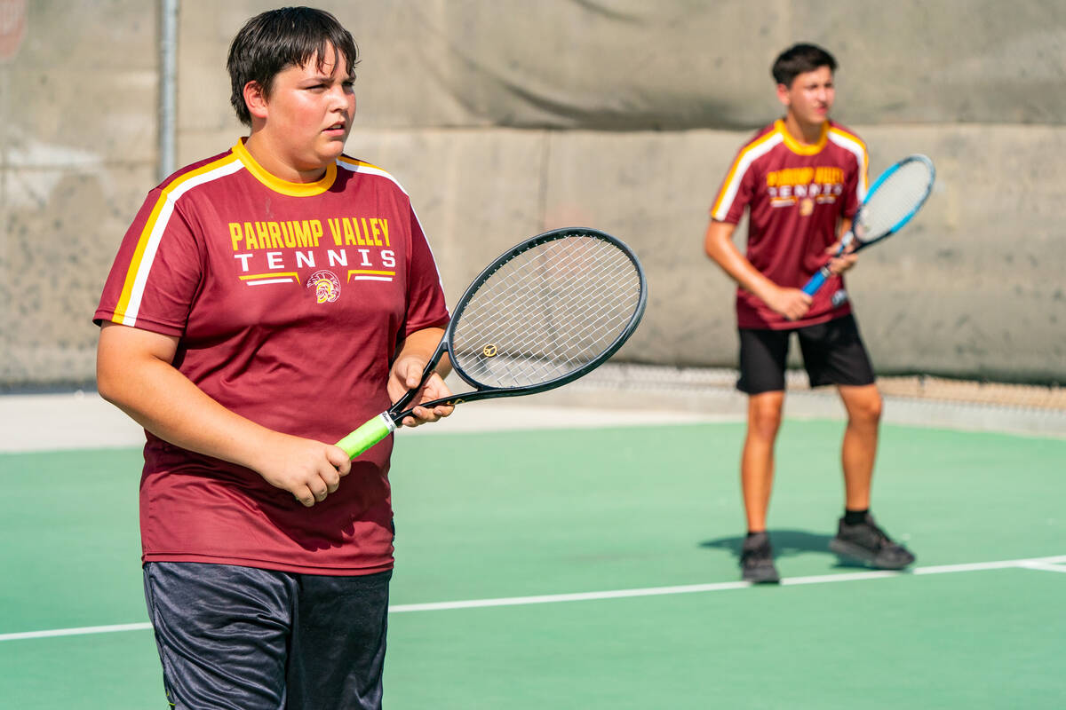 Trojans Lucas Johnson (left) and Jace Eichner (right) set up to play doubles in the first round ...