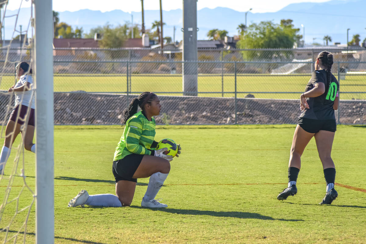 Trojans Madison Williams Mendenhall (12) (center) gets up after blocking a goal attempt from th ...