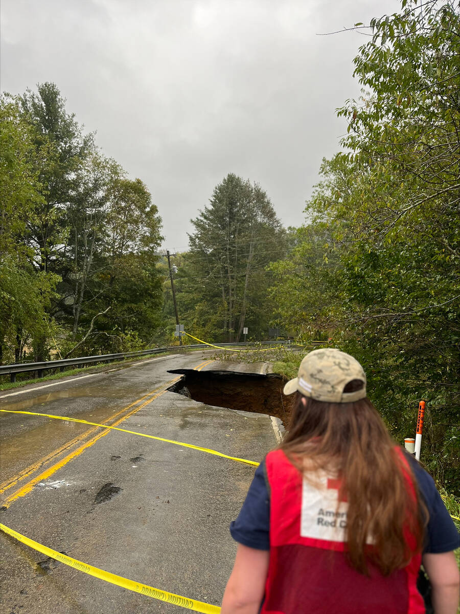 American Red Cross An American Red Cross volunteer surveys a roadway that partially collapsed f ...