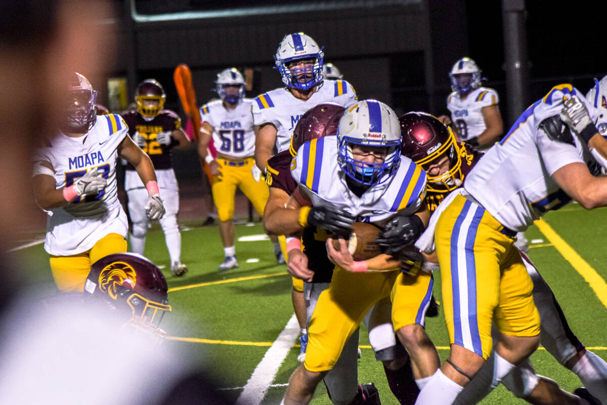 Trojan’s Randal Murray (10) (left) and Austin Alvarez (33) (right) tackle Moapa Valley&# ...