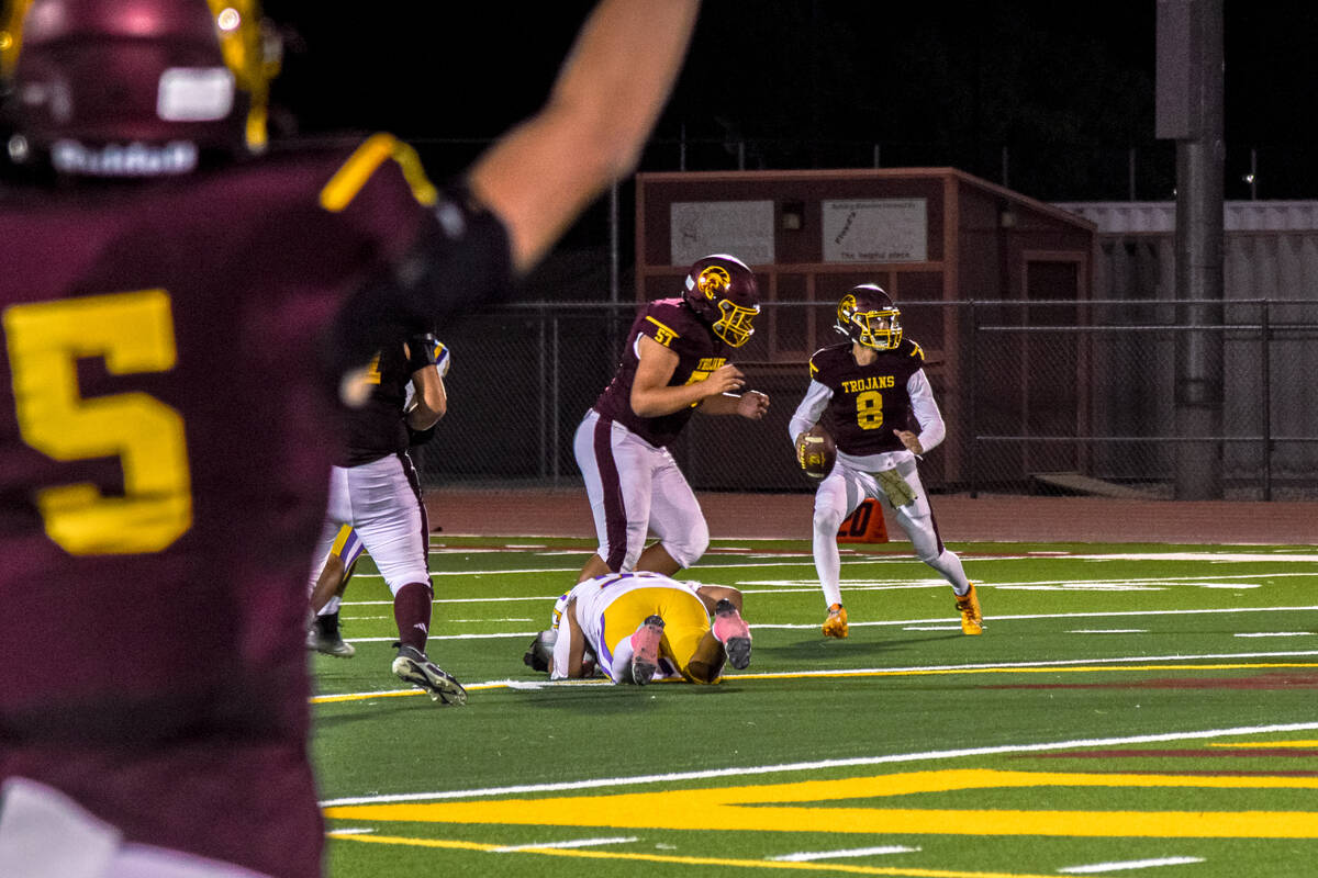 Trojan’s Kayne Horibe (8) (right) looks for a player to throw the ball to as Ethan Hutch ...