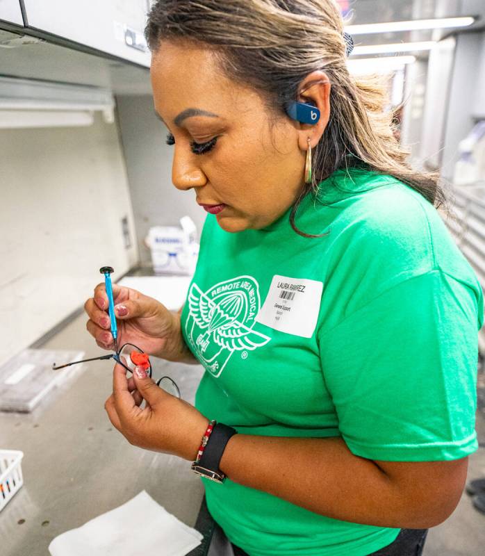 John Clausen/Pahrump Valley Times A Remote Area Medical volunteer adjusts a pair of eyeglass fr ...