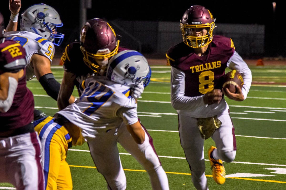 Trojan Kayne Horibe (8) runs toward Moapa Valley's end zone on Thursday, Oct. 10, in Pahrump. T ...