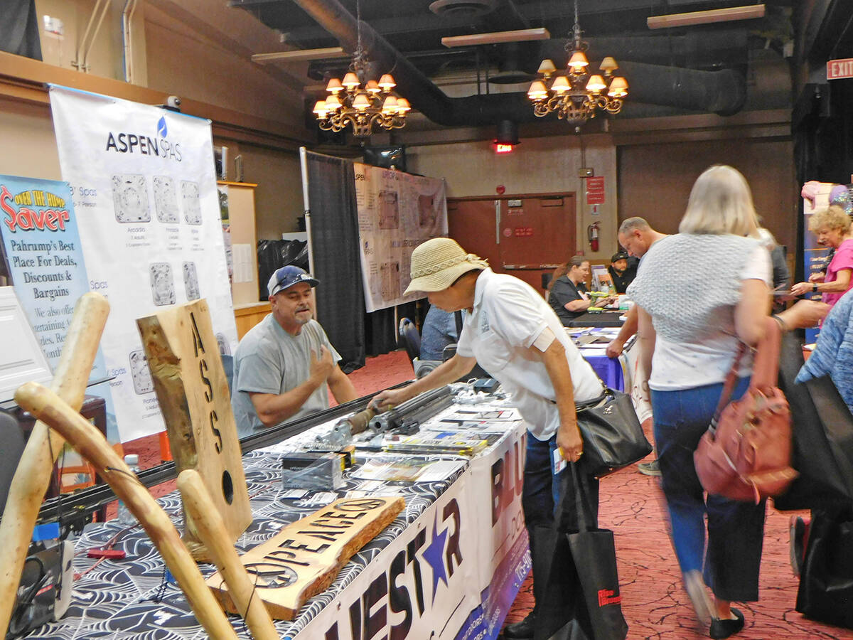 Robin Hebrock/Pahrump Valley Times A Home Show attendee collects some brochures from one of the ...