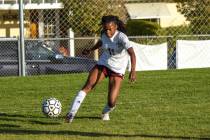 Trojans Diona Nixon (11) attempts to kick the ball out of bounds to slow Boulder City’s ...