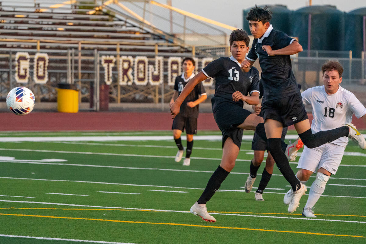 Trojan’s boys soccer TC Hone (7) headbuds the ball towards the Doral Academy on Thursday ...