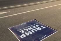 A flattened Trump sign near Manse Road and Clubhouse Drive lays on the road on Wednesday, Oct. ...