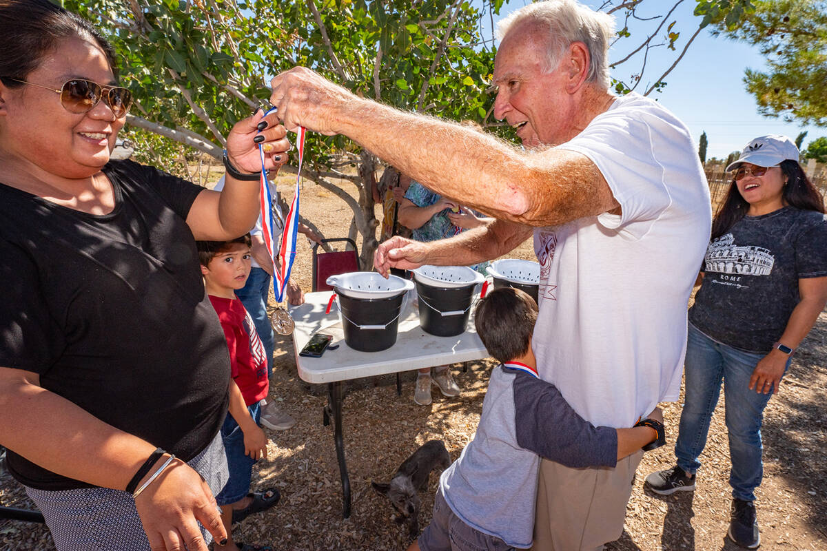 John Clausen/Pahrump Valley Times A Grape Stomp competition winner gives Sanders Winery owner J ...