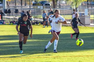 Pahrump Valley’s Rosie Miller (14) (right) runs with the ball towards the penalty box ag ...