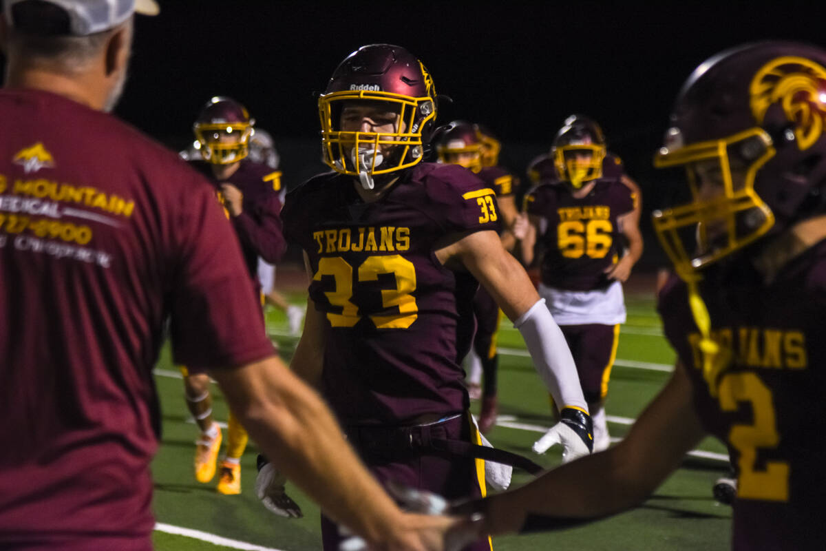 Trojans Austin Alvarez (33) celebrates with his team in the last game of their regular season o ...